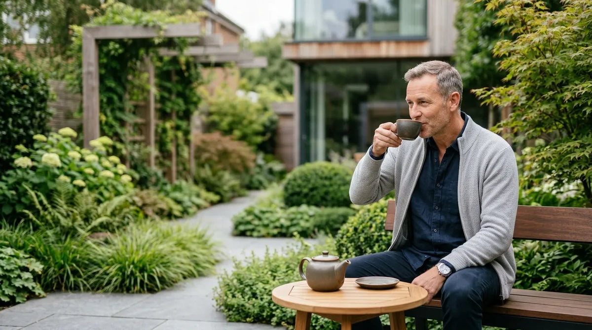 man drinking tea in garden