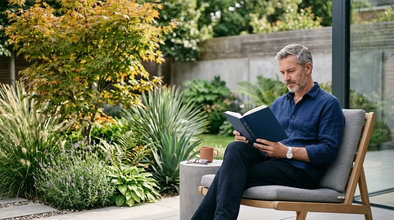 man reading book in garden